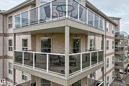 Multi-story building exterior featuring balconies with glass panel railings - 331 9704 174 Street, Edmonton, AB - Outdoor With Exterior