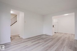 Spacious room with light wood-finish flooring - 