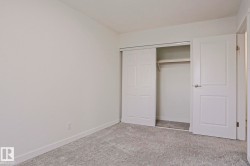 Neutral white walls and light gray patterned carpeting establish a bright aesthetic - 