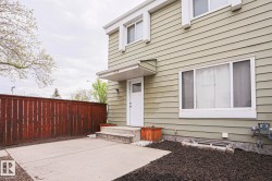 Light green siding exterior with white trim and a concrete patio - 