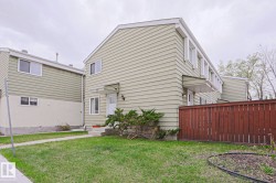 Multi-level exterior featuring light green horizontal siding and white trim - 