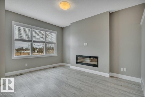 2036 South Creek Drive, Stony Plain, AB - Indoor Photo Showing Living Room With Fireplace