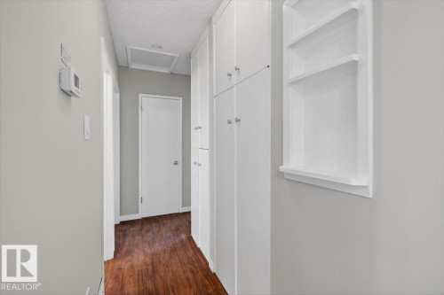 Hallway featuring wood-finish flooring and light gray painted walls - 4630 114 Avenue, Edmonton, AB - Indoor Photo Showing Other Room