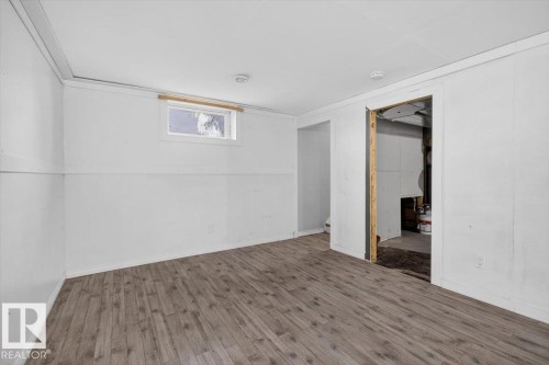 Finished interior room featuring wood-finish flooring, white walls, and a recessed window - 4630 114 Avenue, Edmonton, AB - Indoor Photo Showing Other Room