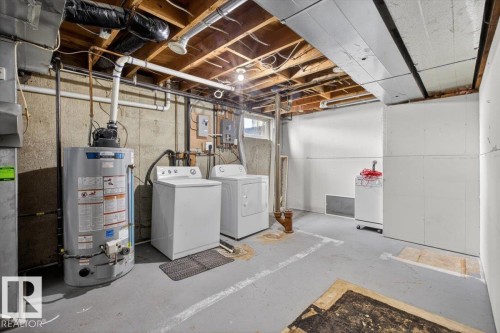 Utility area featuring a water heater, washer, and dryer - 4630 114 Avenue, Edmonton, AB - Indoor Photo Showing Laundry Room