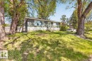 Exterior featuring dark gray siding, white horizontal paneling, a front entry with a storm door, and a large picture window - 4630 114 Avenue, Edmonton, AB  - Outdoor 