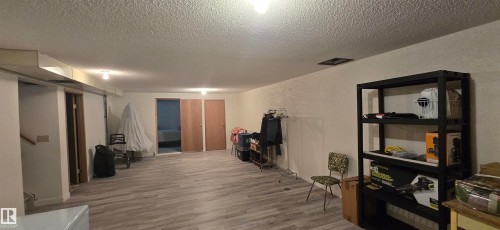 Spacious lower-level room featuring light wood-finish flooring, recessed lighting, and access to additional rooms - 5113 45 B Avenue, Vegreville, AB - Indoor Photo Showing Other Room