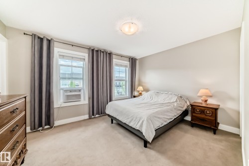 Carpeted room with neutral wall paint and white trim - 2125 24 Street, Edmonton, AB - Indoor Photo Showing Bedroom
