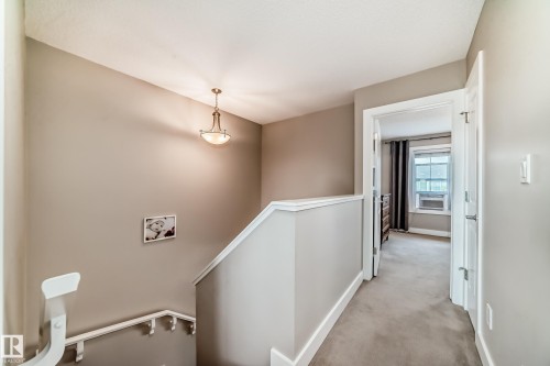 Upper-level landing with neutral tone carpeting and walls - 2125 24 Street, Edmonton, AB - Indoor Photo Showing Other Room