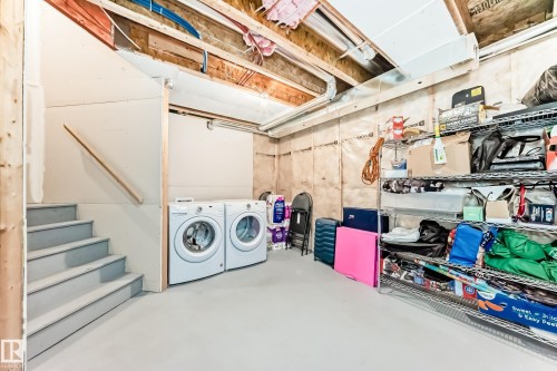 Dedicated laundry area with side-by-side washer and dryer units - 2125 24 Street, Edmonton, AB - Indoor Photo Showing Laundry Room