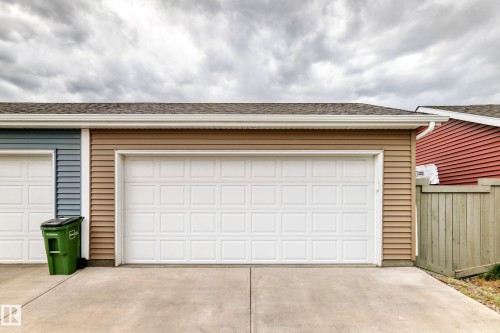 Attached two-car garage with white paneled garage doors - 2125 24 Street, Edmonton, AB - Outdoor