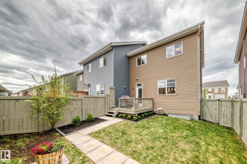 Rear exterior featuring a wood deck, private yard, and horizontal siding - 2125 24 Street, Edmonton, AB - Outdoor With Deck Patio Veranda With Exterior