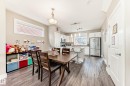 Open-concept living space featuring wood-finish flooring, a contemporary kitchen, and built-in white cabinetry - 2125 24 Street, Edmonton, AB  - Indoor Photo Showing Dining Room 