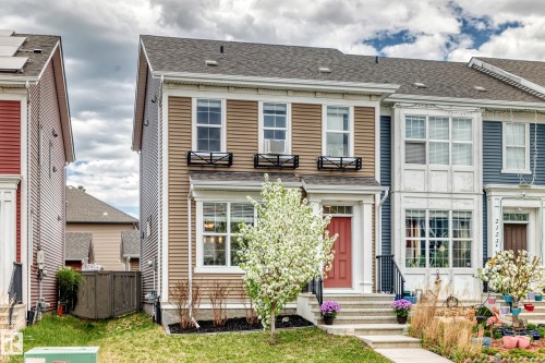 Two-story residence featuring light brown horizontal siding with white trim accents - 2125 24 Street, Edmonton, AB - Outdoor With Facade