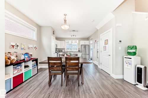 Open-concept main living area with wood-finish flooring, recessed lighting, and crown molding - 2125 24 Street, Edmonton, AB - Indoor Photo Showing Dining Room