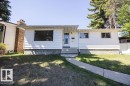 Ranch-style residence featuring white horizontal siding and a stone-clad foundation - 8714 164 Street, Edmonton, AB 