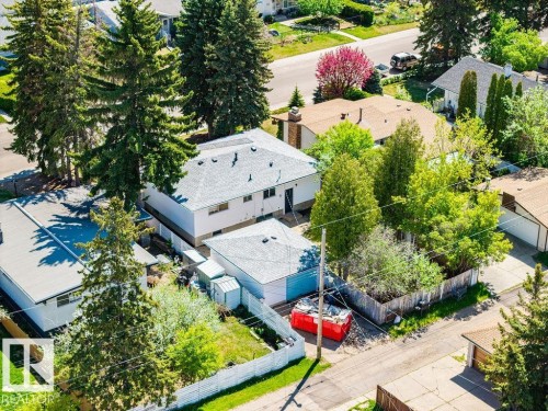 Aerial perspective showcasing two residential structures with white exteriors and grey shingle roofs - 8714 164 Street, Edmonton, AB 