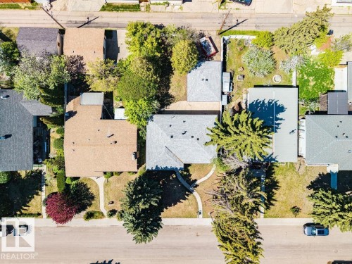 Aerial view showcasing a residential property with a shingle roof and a spacious backyard - 8714 164 Street, Edmonton, AB 