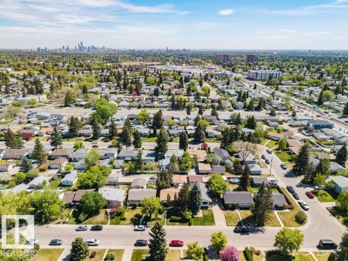 Aerial perspective showcasing a residential neighborhood with a distant city skyline - 8714 164 Street, Edmonton, AB 