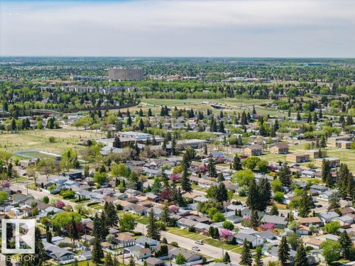 Expansive aerial view showcasing a residential area characterized by numerous mature trees and green spaces - 8714 164 Street, Edmonton, AB 