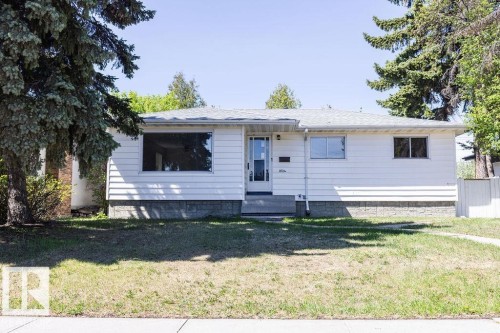 White horizontal siding exterior with a stone-look foundation - 8714 164 Street, Edmonton, AB 