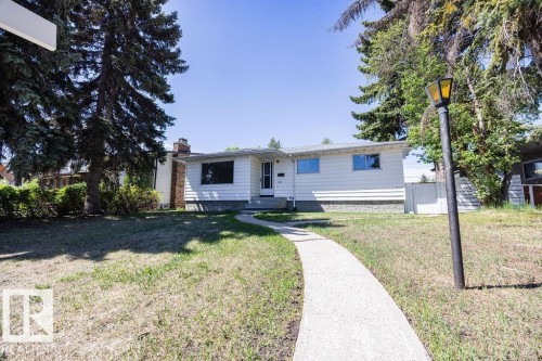 Ranch-style residence featuring white siding and a brick chimney - 8714 164 Street, Edmonton, AB 