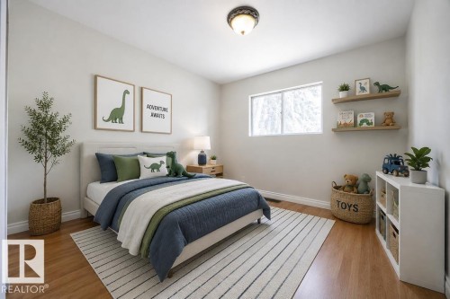 Bright bedroom featuring wood-finish flooring, a contemporary window, and clean white walls. Photo Virtually Staged. - 8714 164 Street, Edmonton, AB 
