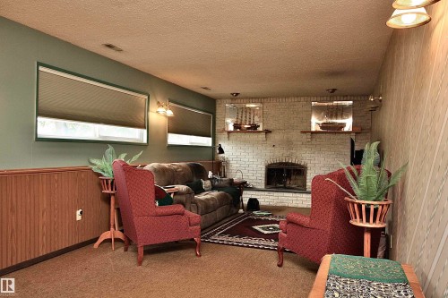Rec Room or Family Room area with wood-burning fireplace. - 13315 136 Street, Edmonton, AB - Indoor With Fireplace