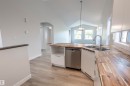 Kitchen featuring wood-finish countertops, dual stainless steel sink, and integrated dishwasher - 738 Kananaskis Drive, Devon, AB  - Indoor Photo Showing Kitchen With Double Sink 