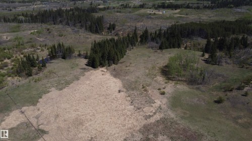 Offering a diverse landscaped opportunity to design your ultimate country estate. With rolling hills, open pasture, and mature woods, the land is a blank canvas ready for your vision." - 563003 Range Road 205, Rural Lamont County, AB 