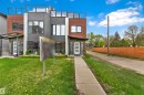 Modern townhouse exterior featuring a multi-level facade with wood-finish siding and dark gray stucco - 9329 Connors Road, Edmonton, AB  - Outdoor 