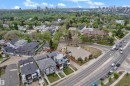Aerial perspective showcasing the property's location within a developed neighborhood, featuring residential buildings, mature trees, and a visible roadway - 9329 Connors Road, Edmonton, AB  - Outdoor With View 