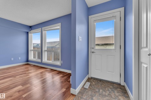 Room featuring wood-finish flooring, white baseboards, and two window units - 432 Watt Boulevard, Edmonton, AB - Indoor Photo Showing Other Room