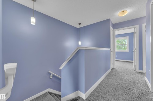 Upper-level hallway with periwinkle walls, white trim, and gray carpet - 432 Watt Boulevard, Edmonton, AB - Indoor Photo Showing Other Room