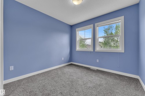 Room featuring soft blue walls, plush gray carpeting, and crisp white baseboards - 432 Watt Boulevard, Edmonton, AB - Indoor Photo Showing Other Room