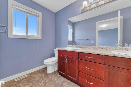 Double vanity with a granite-style countertop and dual undermount sinks - 432 Watt Boulevard, Edmonton, AB - Indoor Photo Showing Bathroom