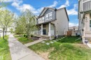 Contemporary two-story residence featuring a covered front porch with white railing, a mixed siding facade, and mature front yard trees - 432 Watt Boulevard, Edmonton, AB  - Outdoor With Deck Patio Veranda 