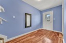 Entryway featuring wood-finish flooring, a white paneled door with integrated glass, and a wall-mounted mirror - 432 Watt Boulevard, Edmonton, AB  - Indoor Photo Showing Other Room 