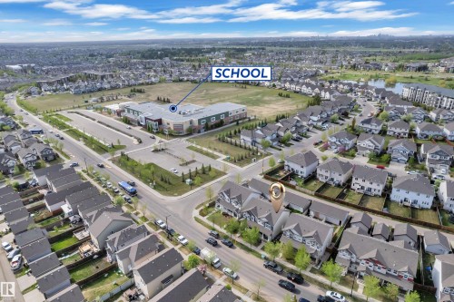 Aerial perspective showcasing a residential neighborhood with a large institutional building and paved parking - 432 Watt Boulevard, Edmonton, AB - Outdoor With View