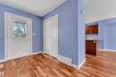 Entryway featuring wood-finish flooring, a white paneled door with a multi-pane window, and a bi-fold closet - 432 Watt Boulevard, Edmonton, AB  - Indoor Photo Showing Other Room 