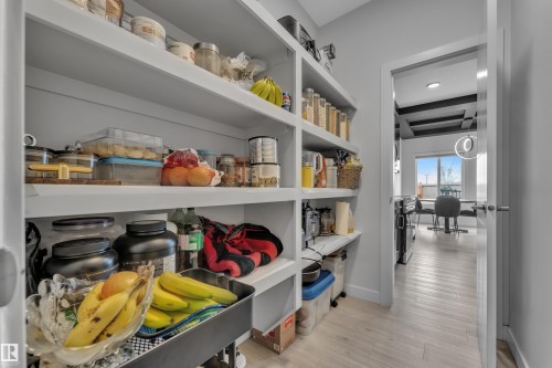 Built-in shelving unit providing extensive storage, complemented by light wood-finish flooring - 1118 Goldfinch Crescent, Edmonton, AB - Indoor