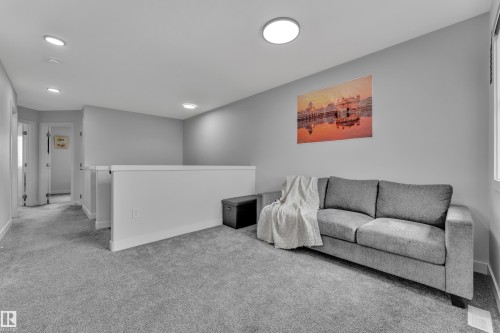 Upper-level landing featuring light gray walls, recessed ceiling lighting, a partial wall with a white cap, and gray carpeting - 1118 Goldfinch Crescent, Edmonton, AB - Indoor