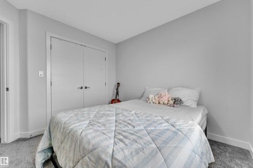 Light gray painted walls complement the gray carpeting - 1118 Goldfinch Crescent, Edmonton, AB - Indoor Photo Showing Bedroom