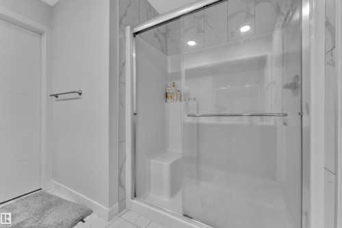 Walk-in shower with clear glass enclosure and integrated seating - 1118 Goldfinch Crescent, Edmonton, AB - Indoor Photo Showing Bathroom