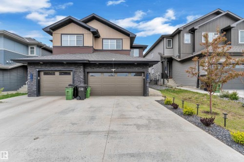 Contemporary two-story residence featuring a dual-tone exterior with a stone facade - 1118 Goldfinch Crescent, Edmonton, AB - Outdoor With Facade
