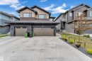 Contemporary two-story residence featuring a dual-tone exterior with a stone facade - 1118 Goldfinch Crescent, Edmonton, AB  - Outdoor With Facade 