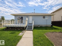 Rear exterior featuring light blue siding and a light gray deck - 