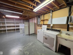 Utility room with a washing machine, dryer, and an adjacent utility sink - 