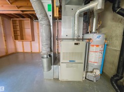 Utility area featuring a furnace and water heater - 