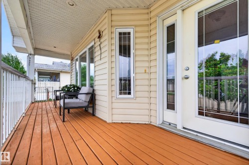 Expansive exterior deck featuring durable wood-finish flooring, white railing, and a textured ceiling with recessed lighting - 1727 Jubilee Loop, Sherwood Park, AB - Outdoor With Deck Patio Veranda With Exterior